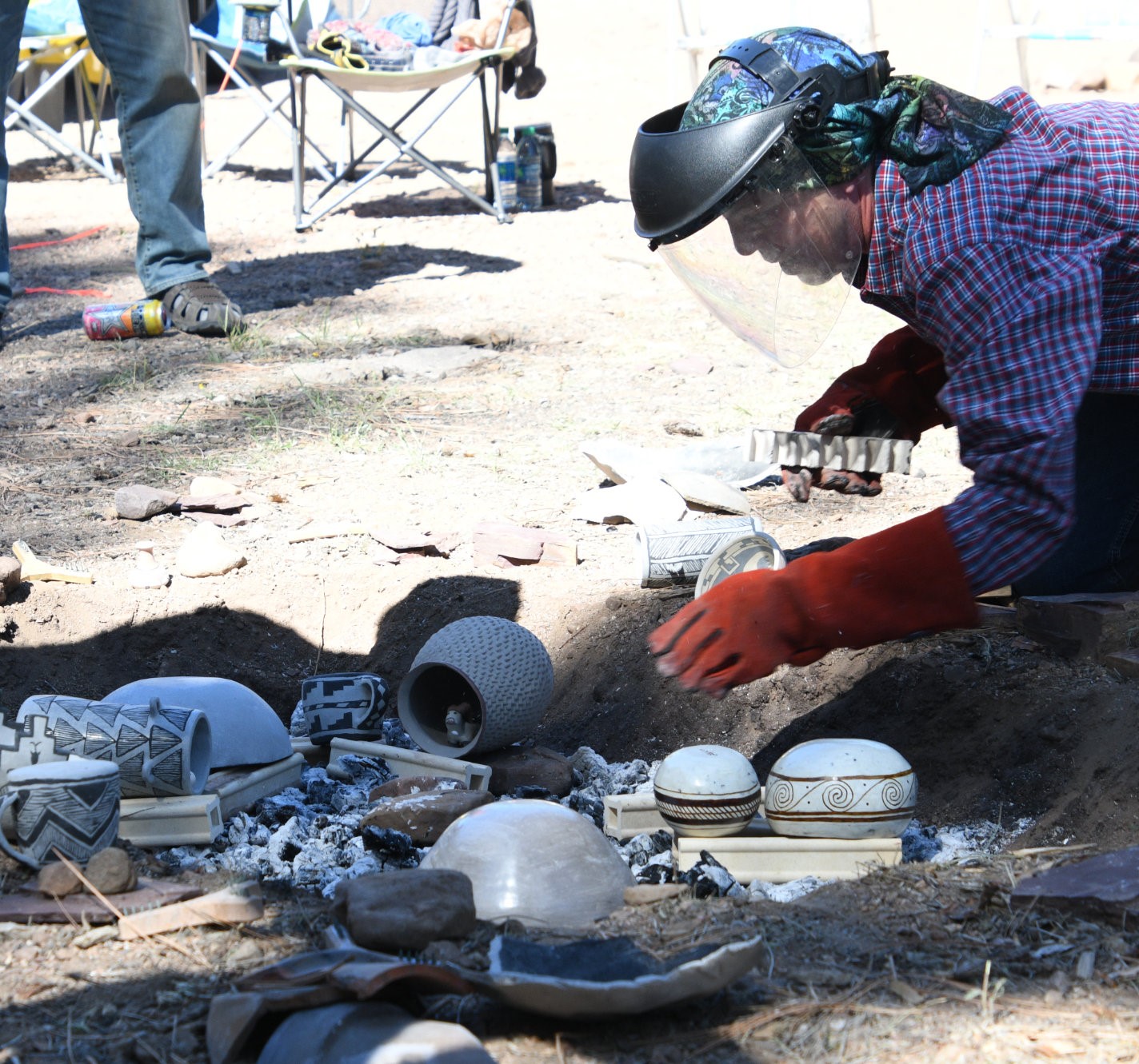 Setting ancient pottery replicas in a trench kiln